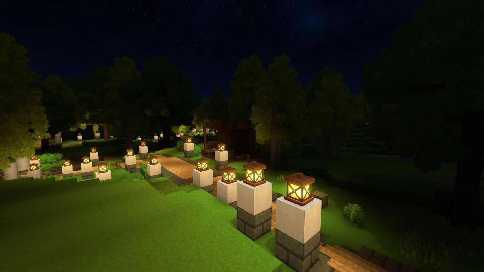 Lantern posts light a winding road through a dark forest under the stars